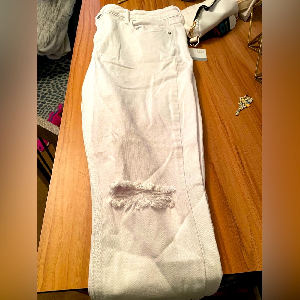 White distressed capri crop jeans.